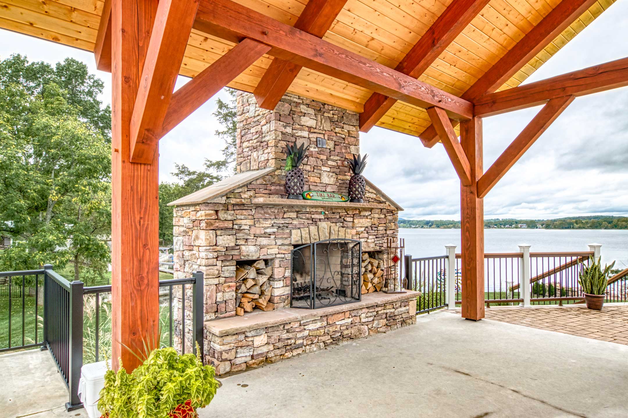 Blue Ridge Timberwrights - Claytor Lake Pavilion decorated patio with fireplace