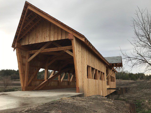 Blue Ridge Timberwrights - Burr Arch Covered Bridge balcony overlooking creek, front view