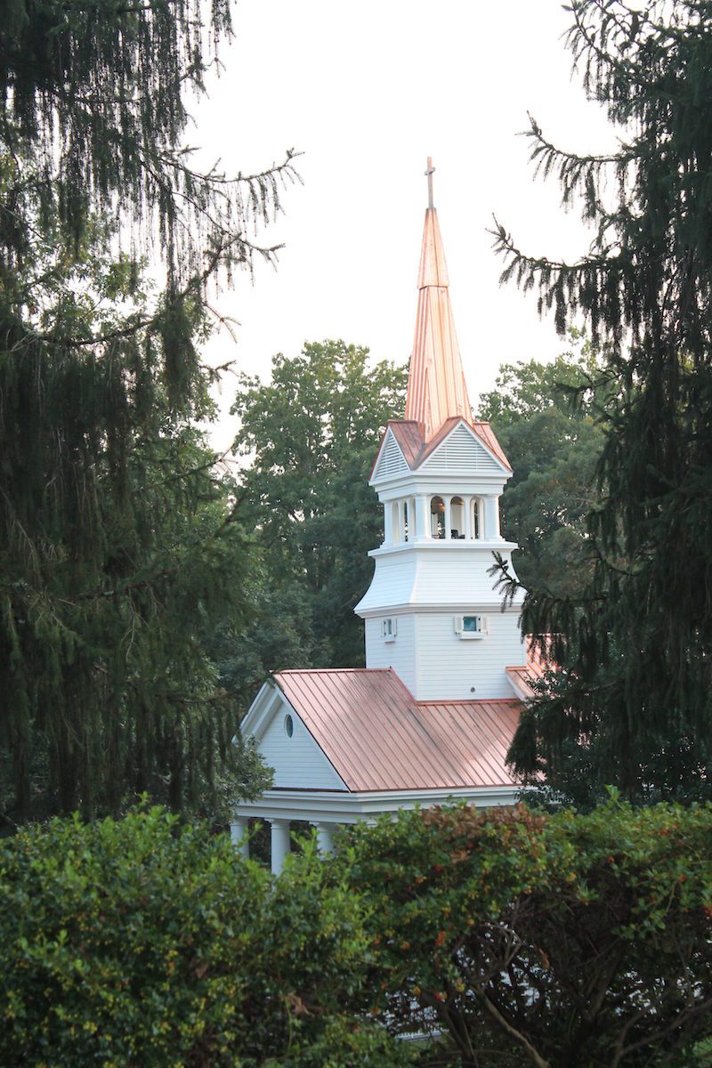 The Greenbrier Chapel steeple finished through trees