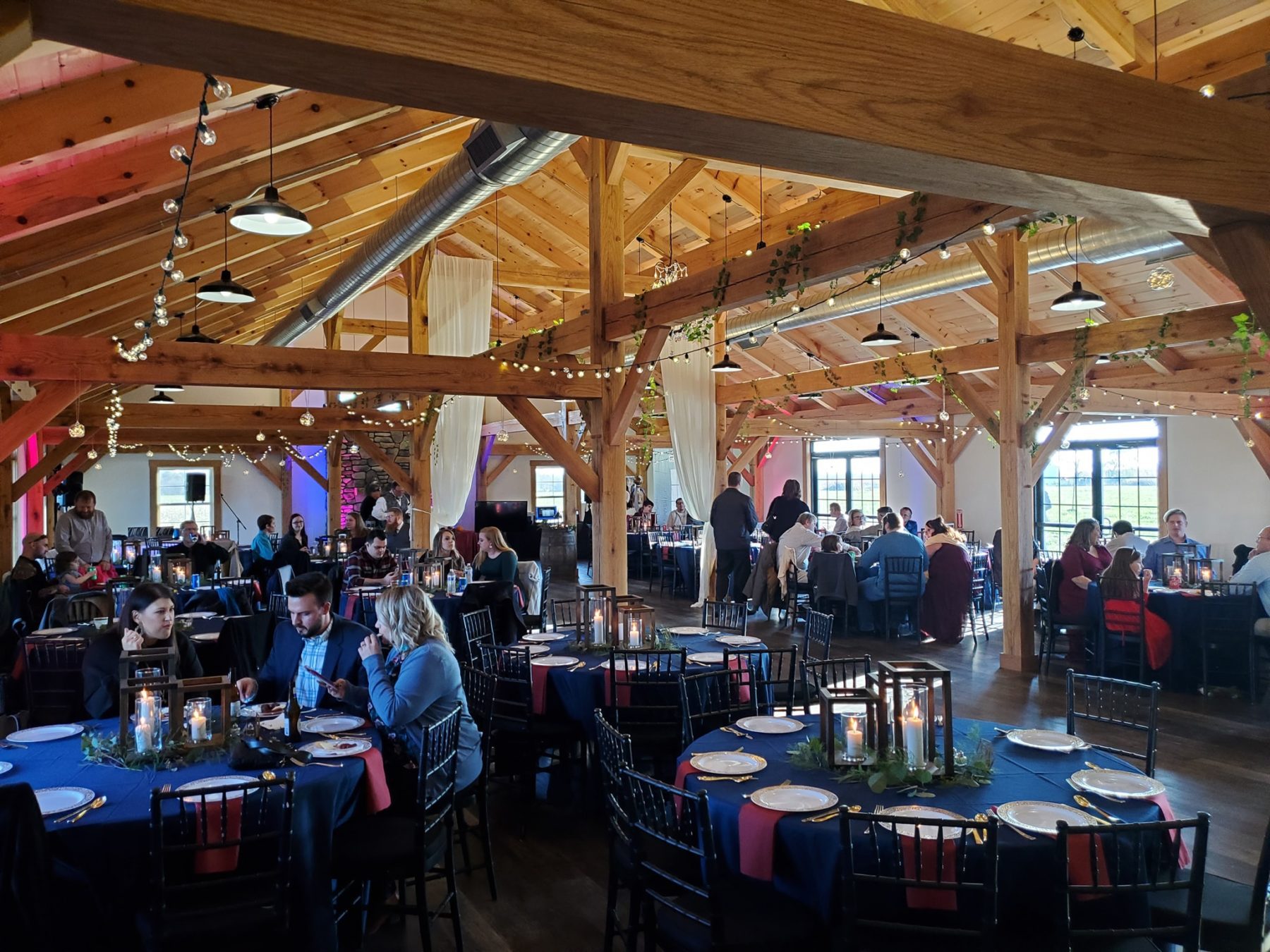 Guests at a party, blue tables - Fox Meadow Barn - Blue Ridge Timberwrights Event Venues Gallery